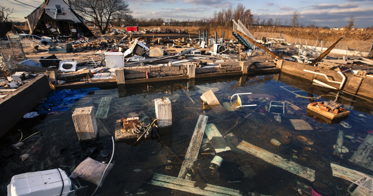 A still running water pipe floods the foundation of a home destroyed by the storm surge of superstorm Sandy in the Staten Island borough neighborhood of Oakwood in New York